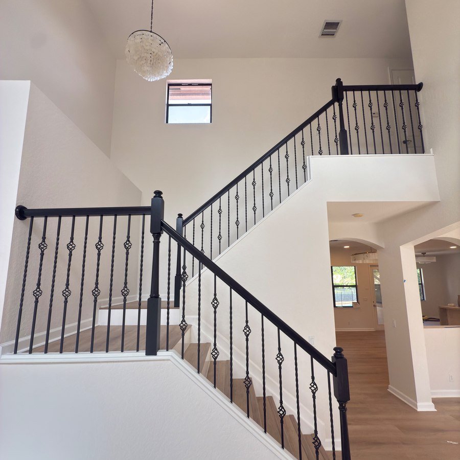 Two-story foyer with wrought iron staircase railing, full home renovation