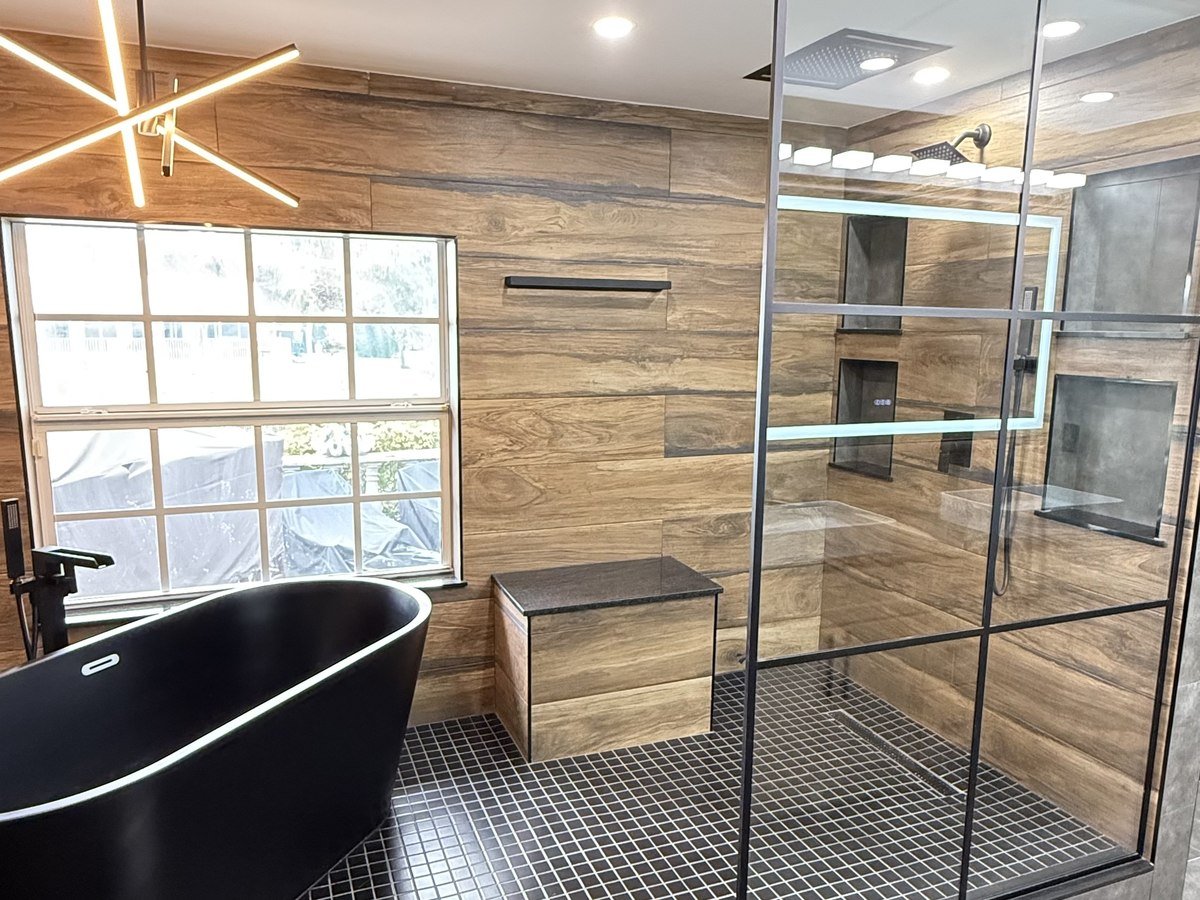 Industrial-modern bathroom with black-framed glass and matte black fixtures